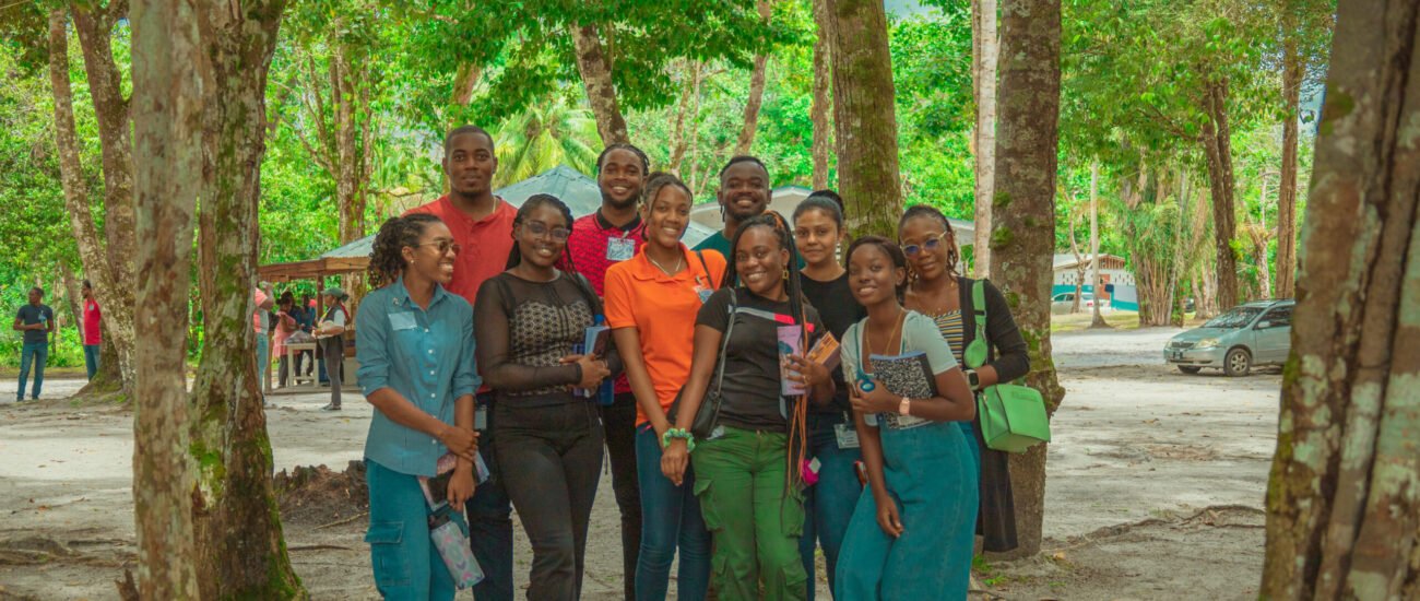 Image of a group of people standing in a wooded area at Conclave 2025 Event