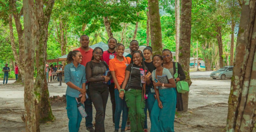 Image of a group of people standing in a wooded area at Conclave 2025 Event