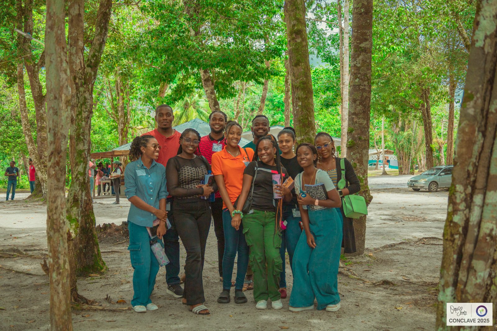 Image of a group of people standing in a wooded area at Conclave 2025 Event